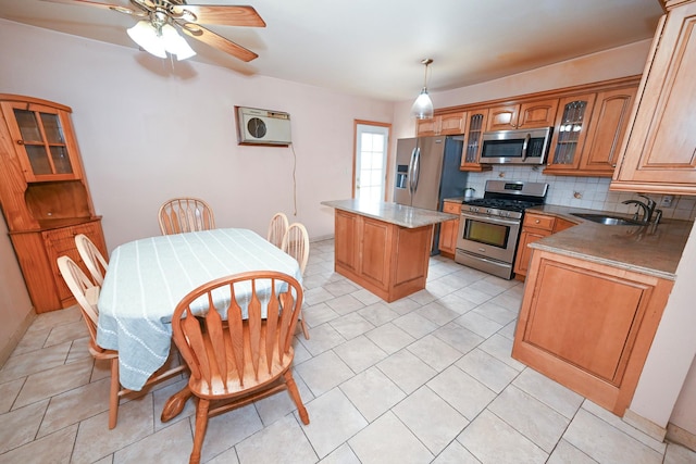 5920 69th Pl, Maspeth, NY 11378 - kitchen featuring appliances with stainless steel finishes, a kitchen island, decorative backsplash, glass insert cabinets, and ceiling fan