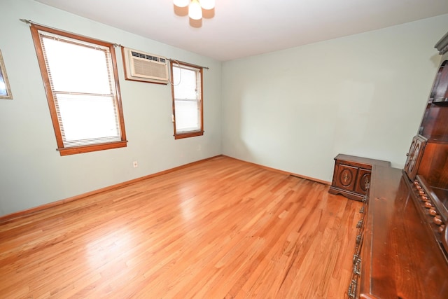 5920 69th Pl, Maspeth, NY 11378 - unfurnished room featuring a wall mounted AC, light wood-style floors, and ceiling fan