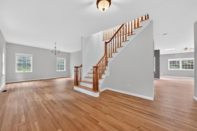 16 Apple Summit Ln, Lagrangeville, NY 12540 - stairway featuring wood finished floors, a chandelier, and a ceiling fan