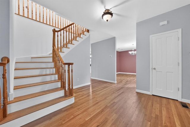 16 Apple Summit Ln, Lagrangeville, NY 12540 - staircase featuring wood finished floors and a chandelier