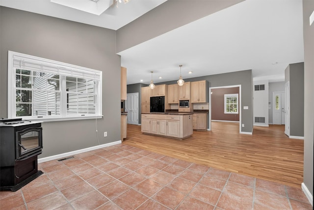 16 Apple Summit Ln, Lagrangeville, NY 12540 - kitchen with refrigerator, stainless steel microwave, light brown cabinets, light tile patterned flooring, and dark countertops
