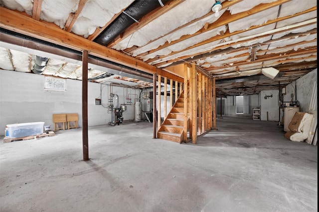 16 Apple Summit Ln, Lagrangeville, NY 12540 - unfinished basement featuring stairway, strapped water heater, and gas water heater