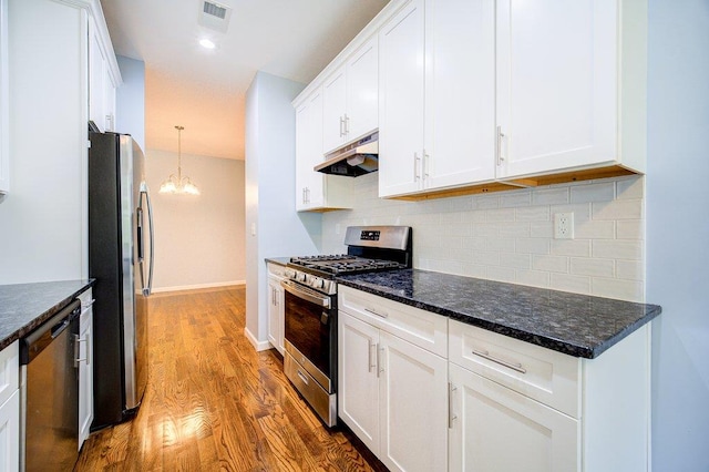 31 Pinto Rd W, Middletown, NY 10941 - kitchen featuring appliances with stainless steel finishes, under cabinet range hood, a chandelier, white cabinetry, and wood finished floors
