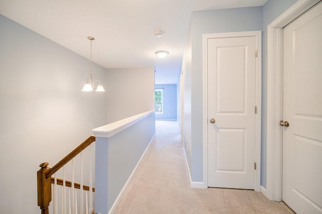 31 Pinto Rd W, Middletown, NY 10941 - hallway with an upstairs landing, light colored carpet, and a chandelier