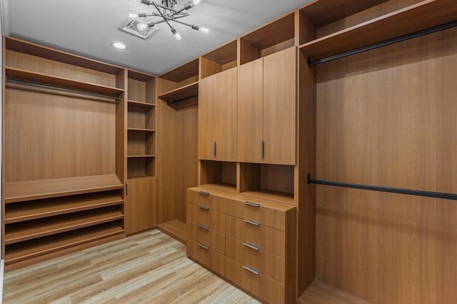 105 Valley Rd, White Plains, NY 10604 - walk in closet featuring light wood-style flooring and a chandelier