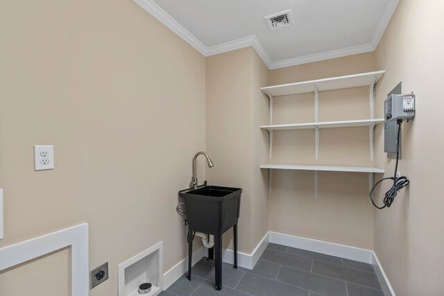 105 Valley Rd, White Plains, NY 10604 - laundry area with electric dryer hookup, ornamental molding, and dark tile patterned floors