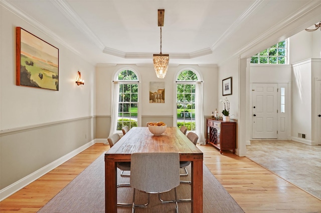 10 Inverness Ct, White Plains, NY 10605 - dining room featuring light wood-style flooring, a chandelier, a raised ceiling, and crown molding