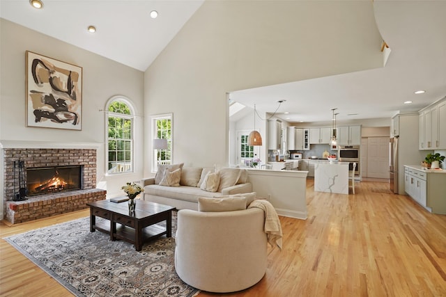 10 Inverness Ct, White Plains, NY 10605 - living area featuring light wood-style floors, high vaulted ceiling, a brick fireplace, and recessed lighting