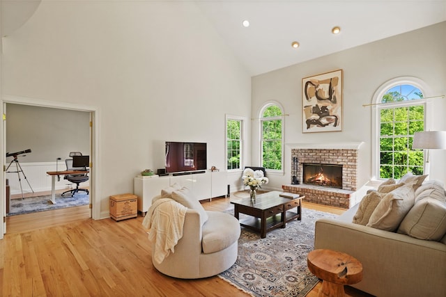10 Inverness Ct, White Plains, NY 10605 - living area featuring high vaulted ceiling, light wood finished floors, and a brick fireplace