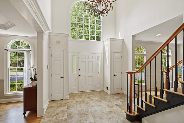 10 Inverness Ct, White Plains, NY 10605 - foyer featuring plenty of natural light, a chandelier, stairs, a towering ceiling, and crown molding