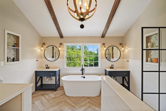 10 Inverness Ct, White Plains, NY 10605 - full bath with tile walls, wainscoting, a soaking tub, a chandelier, and two vanities