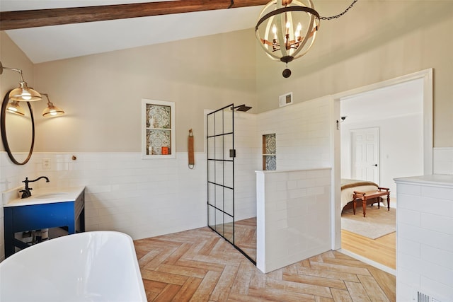 10 Inverness Ct, White Plains, NY 10605 - full bath with a freestanding tub, a chandelier, a walk in shower, tile walls, and a wainscoted wall
