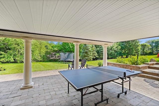10 Inverness Ct, White Plains, NY 10605 - view of patio with a trampoline, view of wooded area, and outdoor dining space