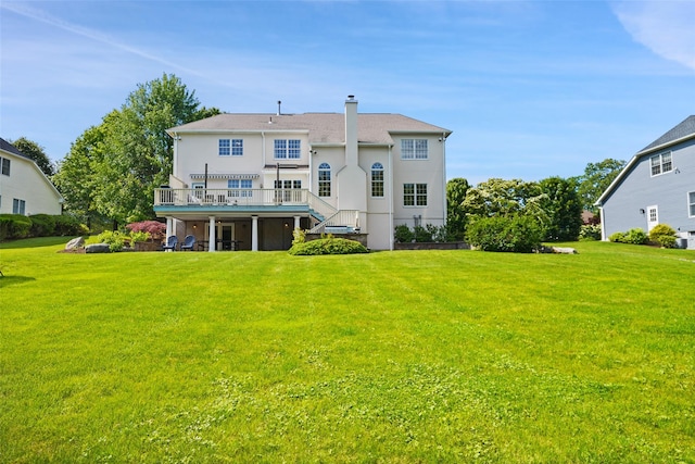 10 Inverness Ct, White Plains, NY 10605 - rear view of house with a deck, a lawn, stairway, and a chimney
