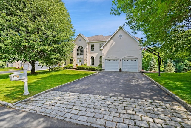 10 Inverness Ct, White Plains, NY 10605 - view of front of house featuring asphalt driveway, stucco siding, a front lawn, and an attached garage
