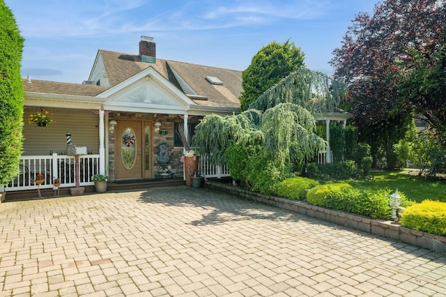 17 Piper Ln, Levittown, NY 11756 - view of front of house with a porch, a chimney, and a shingled roof