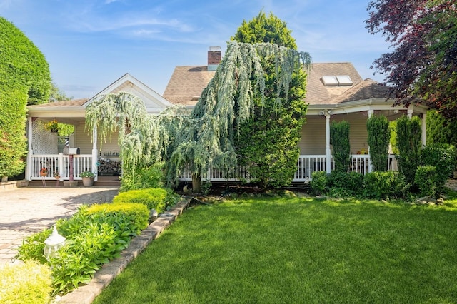 17 Piper Ln, Levittown, NY 11756 - view of property hidden behind natural elements featuring a porch, a front lawn, and roof with shingles