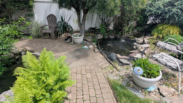 17 Piper Ln, Levittown, NY 11756 - view of patio featuring a garden pond