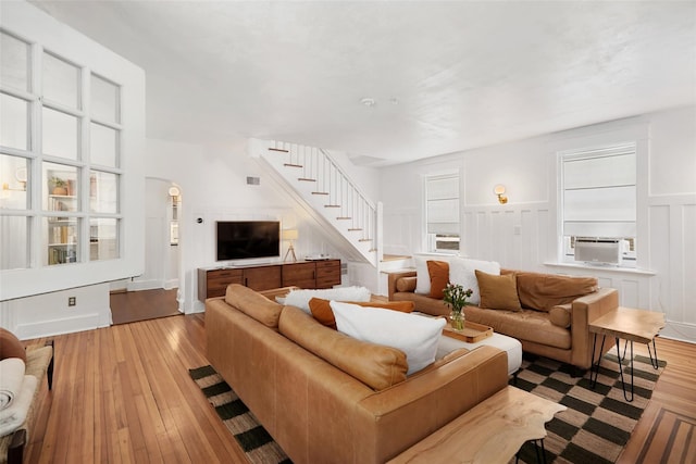 1223 Albany Post Rd, Croton-On-Hudson, NY 10520 - living area featuring stairway, hardwood / wood-style floors, a decorative wall, a wainscoted wall, and cooling unit