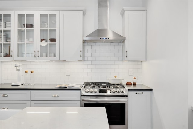 1223 Albany Post Rd, Croton-On-Hudson, NY 10520 - kitchen with wall chimney range hood, gas range, white cabinets, and glass insert cabinets