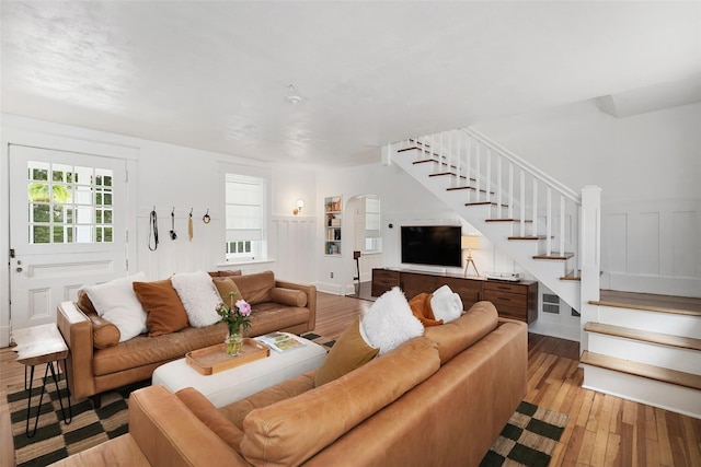 1223 Albany Post Rd, Croton-On-Hudson, NY 10520 - living area featuring arched walkways, stairway, and light wood-type flooring