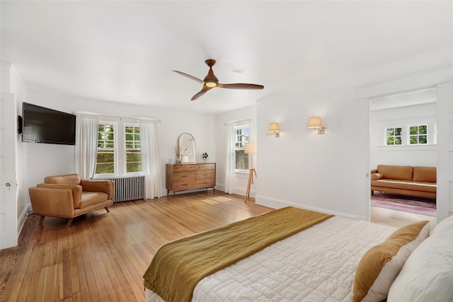 1223 Albany Post Rd, Croton-On-Hudson, NY 10520 - bedroom with radiator, wood-type flooring, and multiple windows