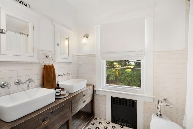 1223 Albany Post Rd, Croton-On-Hudson, NY 10520 - bathroom with radiator, tile walls, double vanity, and wainscoting