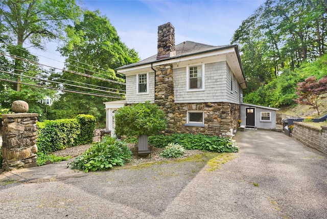 1223 Albany Post Rd, Croton-On-Hudson, NY 10520 - view of front of home with asphalt driveway, stone siding, and a chimney