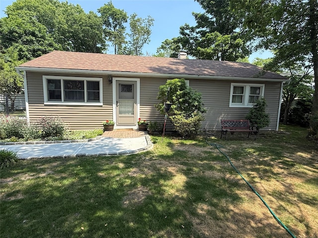 1016 Howells Rd, Bay Shore, NY 11706 - view of front of house with a front yard, a chimney, and roof with shingles