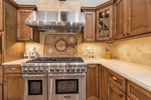 95 Falmouth Pl, Albertson, NY 11507 - kitchen featuring double oven range, range hood, brown cabinetry, light countertops, and glass insert cabinets
