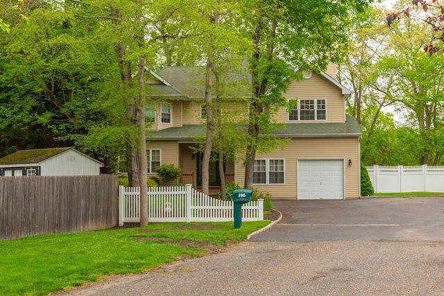 195 Bridle Way, Oakdale, NY 11769 - view of front of house with a fenced front yard, a chimney, a garage, and asphalt driveway