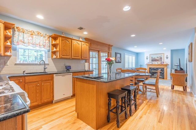 195 Bridle Way, Oakdale, NY 11769 - kitchen with dishwasher, open shelves, a center island, light wood-style floors, and a breakfast bar area