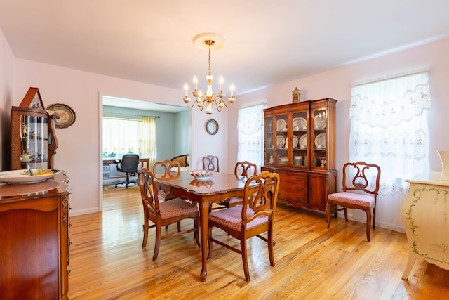 195 Bridle Way, Oakdale, NY 11769 - dining space featuring a chandelier and light wood-style flooring