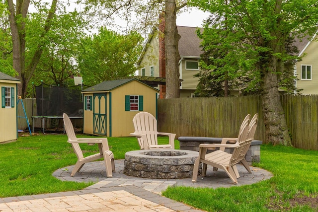 195 Bridle Way, Oakdale, NY 11769 - fenced backyard with a shed, a trampoline, a fire pit, and a patio