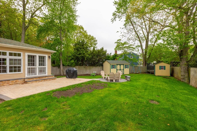 195 Bridle Way, Oakdale, NY 11769 - fenced backyard with a storage unit and a patio