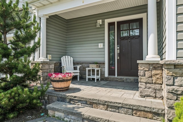 26 Island Pkwy N, Island Park, NY 11558 - view of exterior entry featuring stone siding and a porch