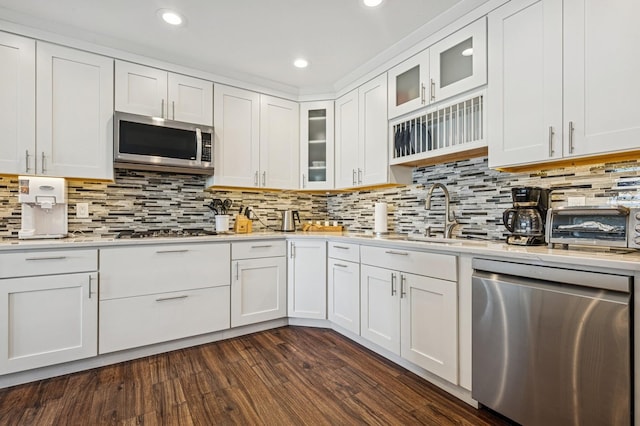 26 Island Pkwy N, Island Park, NY 11558 - kitchen with stainless steel appliances, light countertops, white cabinetry, glass insert cabinets, and recessed lighting