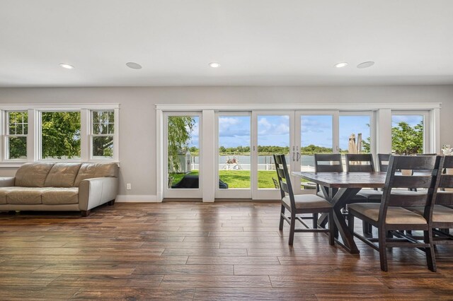 26 Island Pkwy N, Island Park, NY 11558 - dining room featuring dark wood-style flooring, recessed lighting, a water view, and french doors
