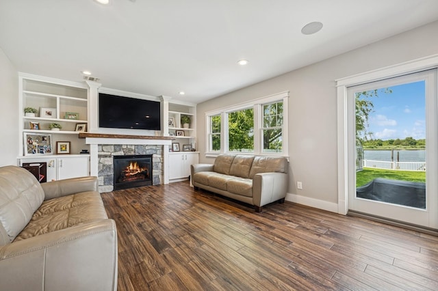 26 Island Pkwy N, Island Park, NY 11558 - living area featuring plenty of natural light, wood finished floors, a fireplace, and recessed lighting