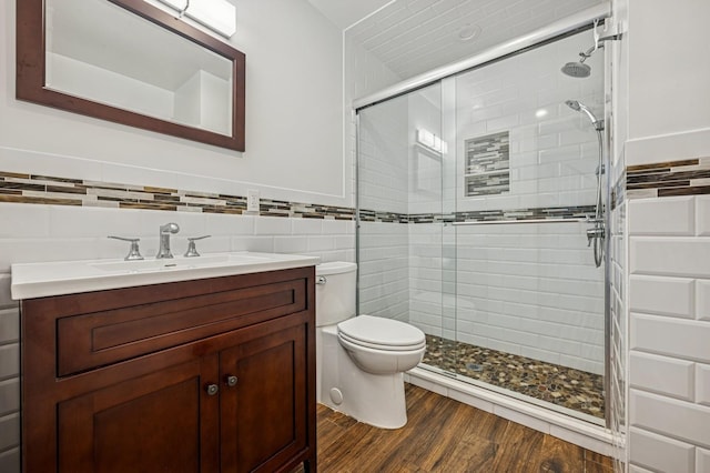 26 Island Pkwy N, Island Park, NY 11558 - bathroom featuring tile walls, a shower stall, vanity, and wood finished floors