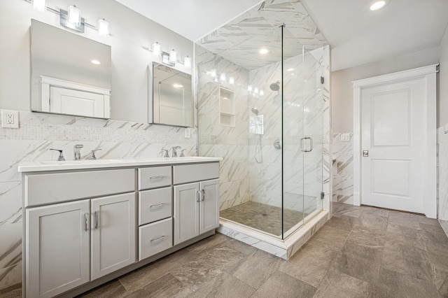 26 Island Pkwy N, Island Park, NY 11558 - bathroom with double vanity, a marble finish shower, recessed lighting, and backsplash