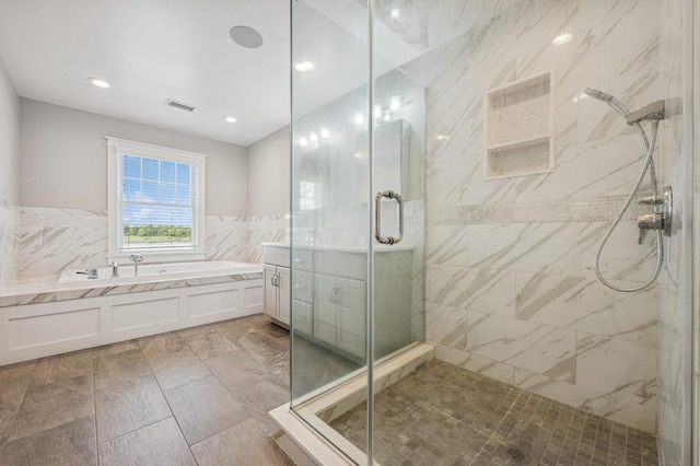 26 Island Pkwy N, Island Park, NY 11558 - bathroom featuring a bath, a marble finish shower, vanity, tile walls, and recessed lighting