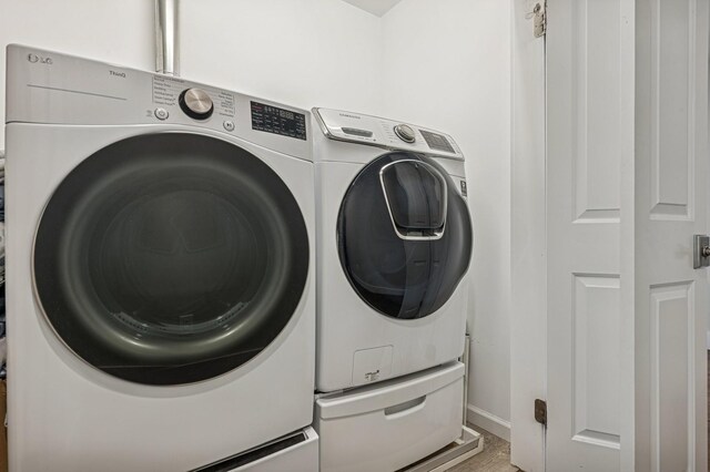 26 Island Pkwy N, Island Park, NY 11558 - laundry room with washer and dryer and wood finished floors