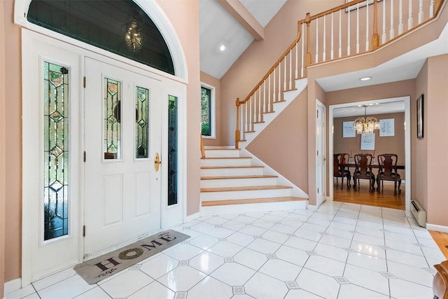 48 Orchard Hill Rd, Carmel, NY 10512 - foyer with a chandelier, stairs, a baseboard heating unit, high vaulted ceiling, and recessed lighting