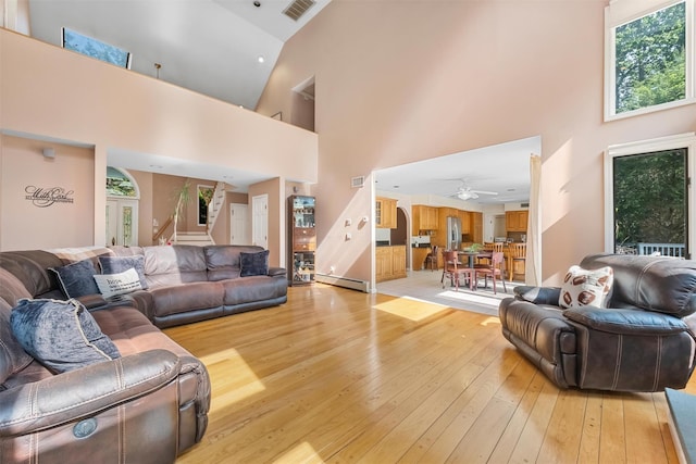 48 Orchard Hill Rd, Carmel, NY 10512 - living room with high vaulted ceiling, light wood-type flooring, stairway, and ceiling fan