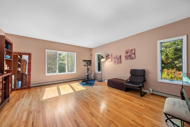 48 Orchard Hill Rd, Carmel, NY 10512 - living area with light wood-style floors, baseboard heating, and a baseboard heating unit
