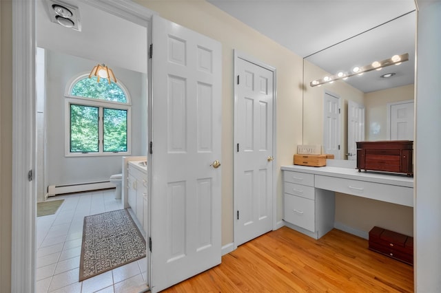 48 Orchard Hill Rd, Carmel, NY 10512 - full bathroom with baseboard heating, vanity, and wood finished floors