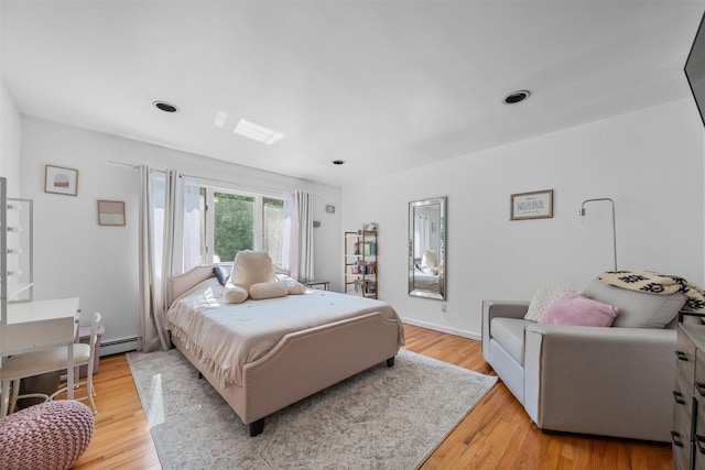 48 Orchard Hill Rd, Carmel, NY 10512 - bedroom with light wood-style flooring and a baseboard heating unit