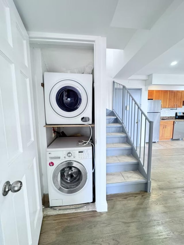 43-18 Robinson Unit 7C, Flushing, NY 11355 - washroom featuring stacked washer / drying machine and light wood finished floors