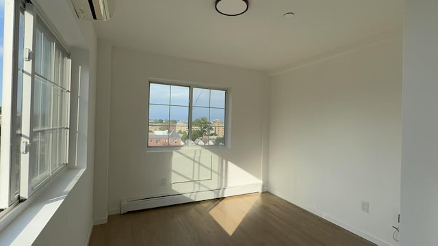 43-18 Robinson Unit 7C, Flushing, NY 11355 - unfurnished room with a baseboard radiator and wood finished floors